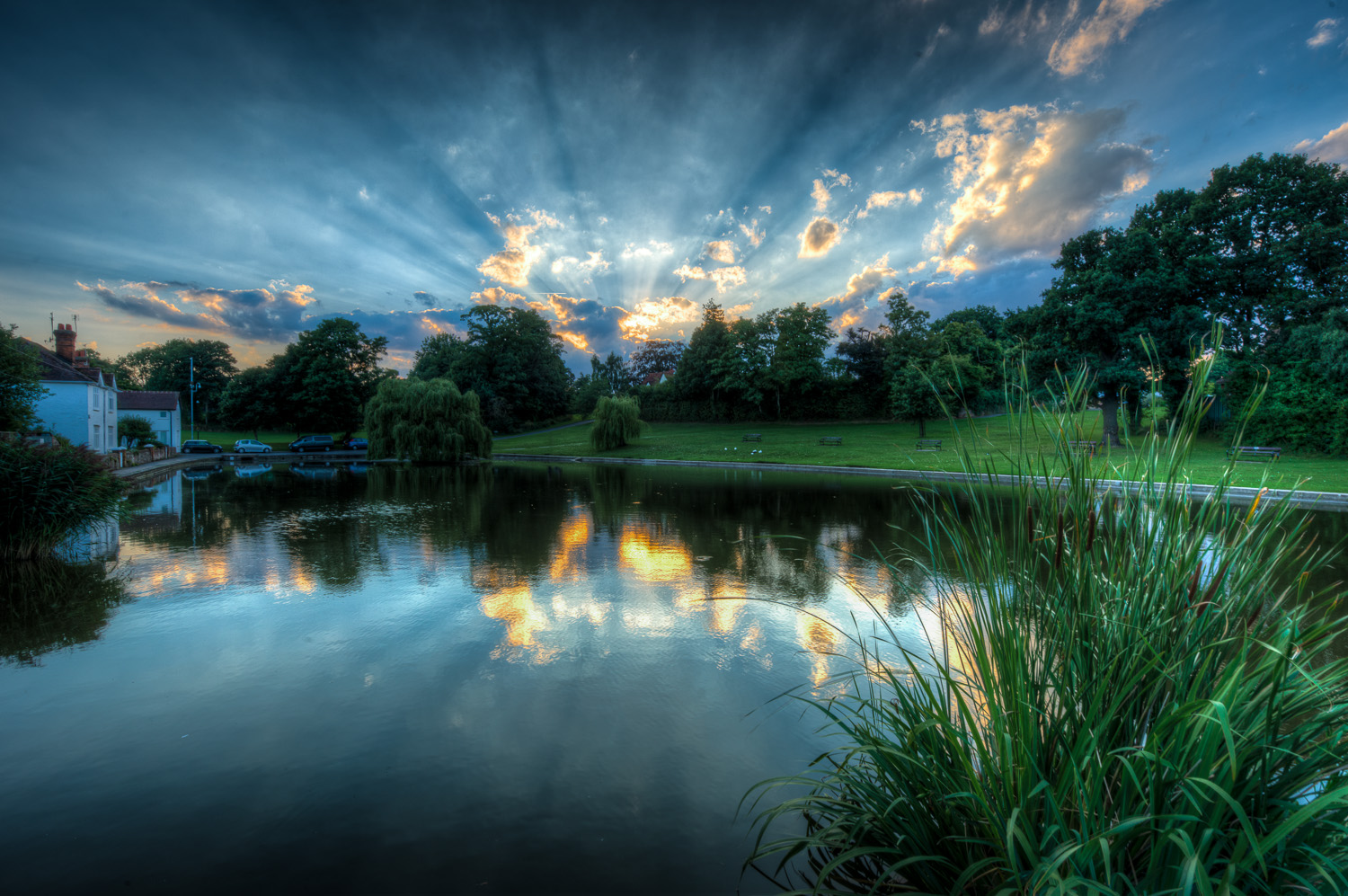 Sun stream at sunset over Doctors Pond, Great Dunmow, Essex